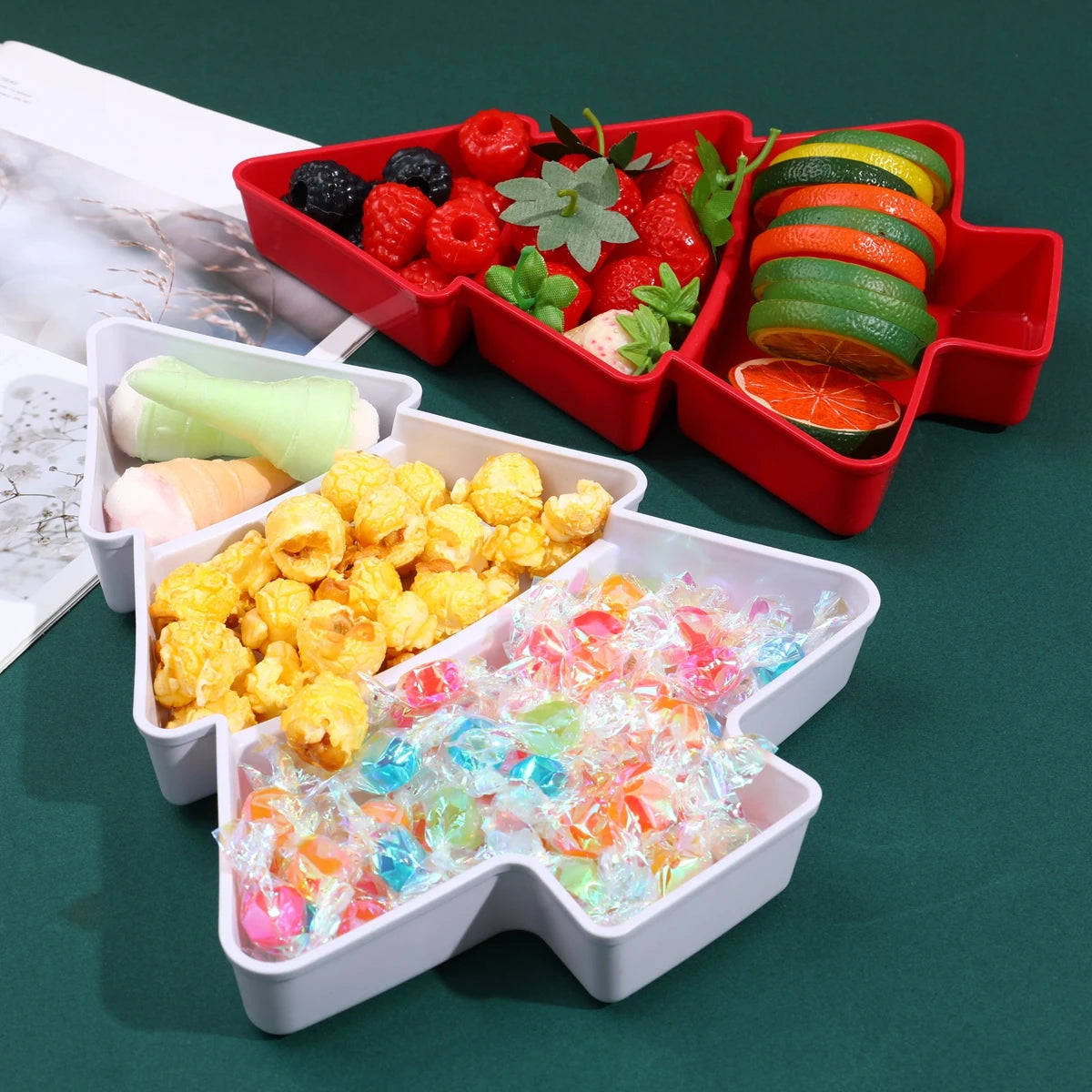 Colorful snack set in a divided Christmas Tree container on a green surface