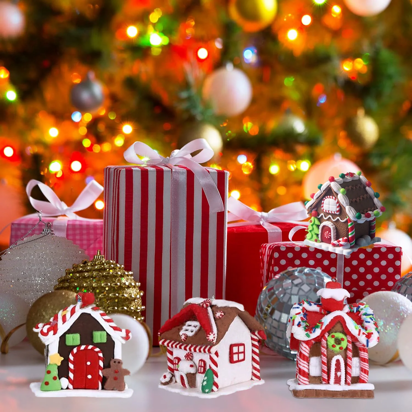Gingerbread houses and presents with a Christmas tree in the background