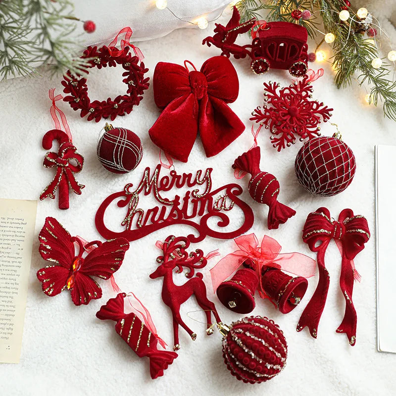 Collection of red Christmas ornaments on a white surface with festive decorations.