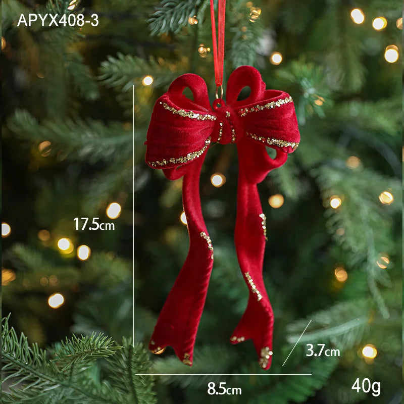 Red bow ornament with gold accents on a Christmas tree