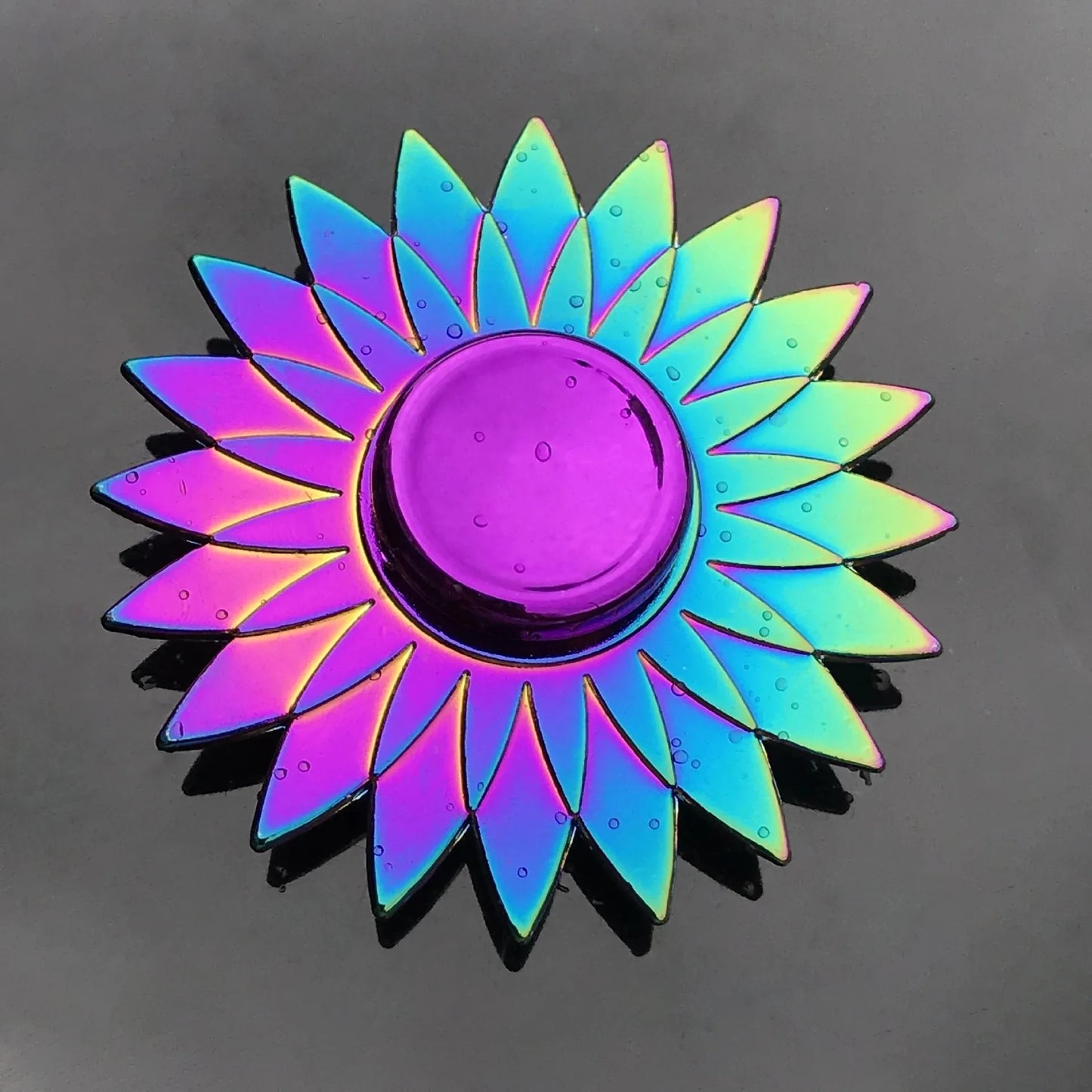 Multicolored sun-shaped object on a dark background