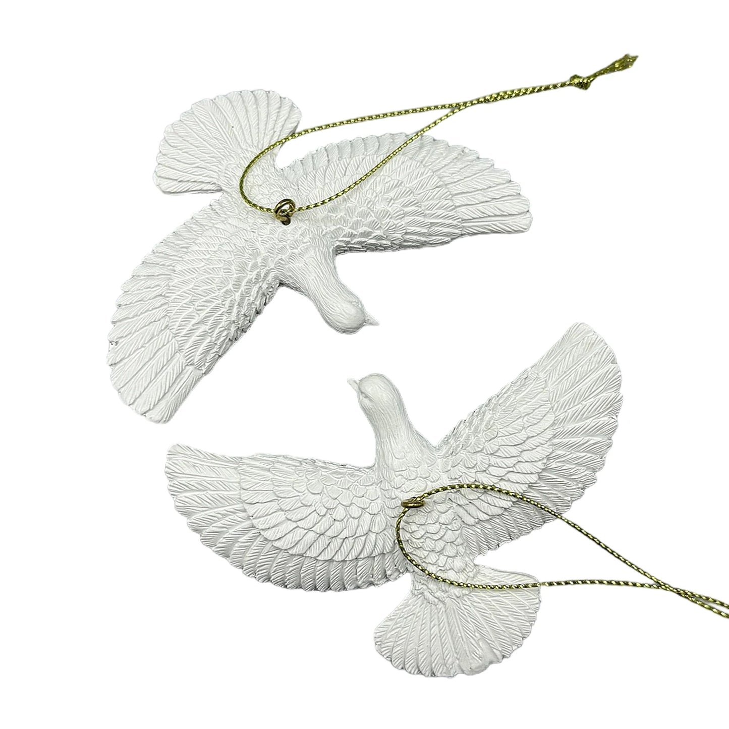 Two white dove ornaments with gold chains on a white background