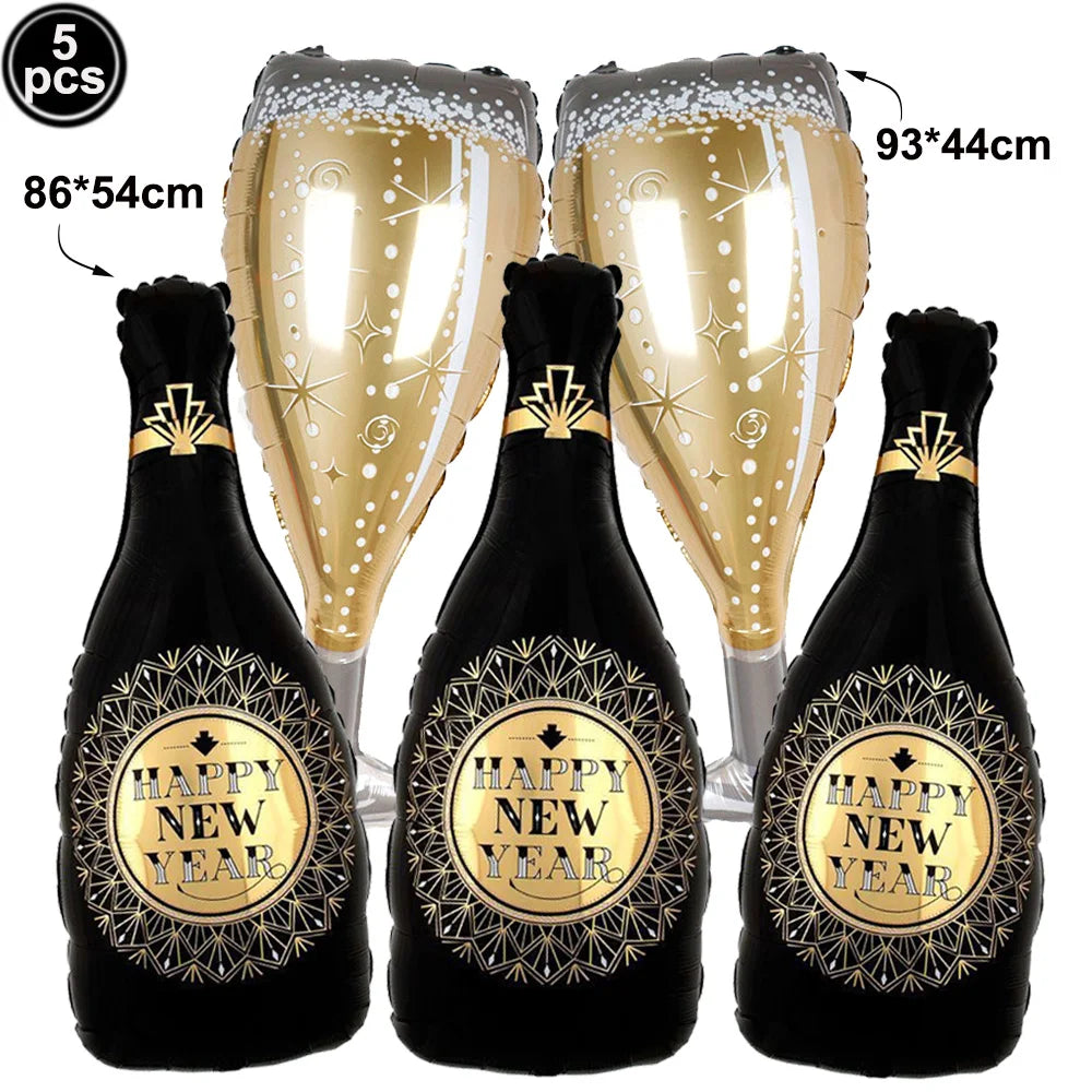 Three inflatable 'Happy New Year' champagne bottles with gold labels on a white background including 2 champagne glasses