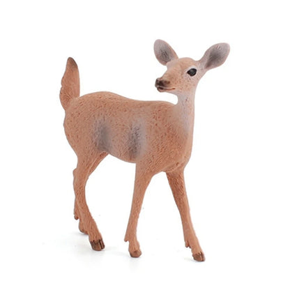 A small deer figurine or toy shown standing on a plain white background. The animal has a light brown body with slightly darker brown legs, hooves, and tail, plus muted grayish patches on its back and ears.