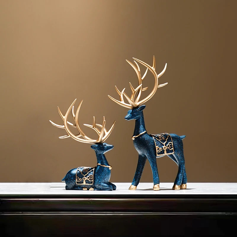 Decorative blue deer figurines with gold antlers on a brown background