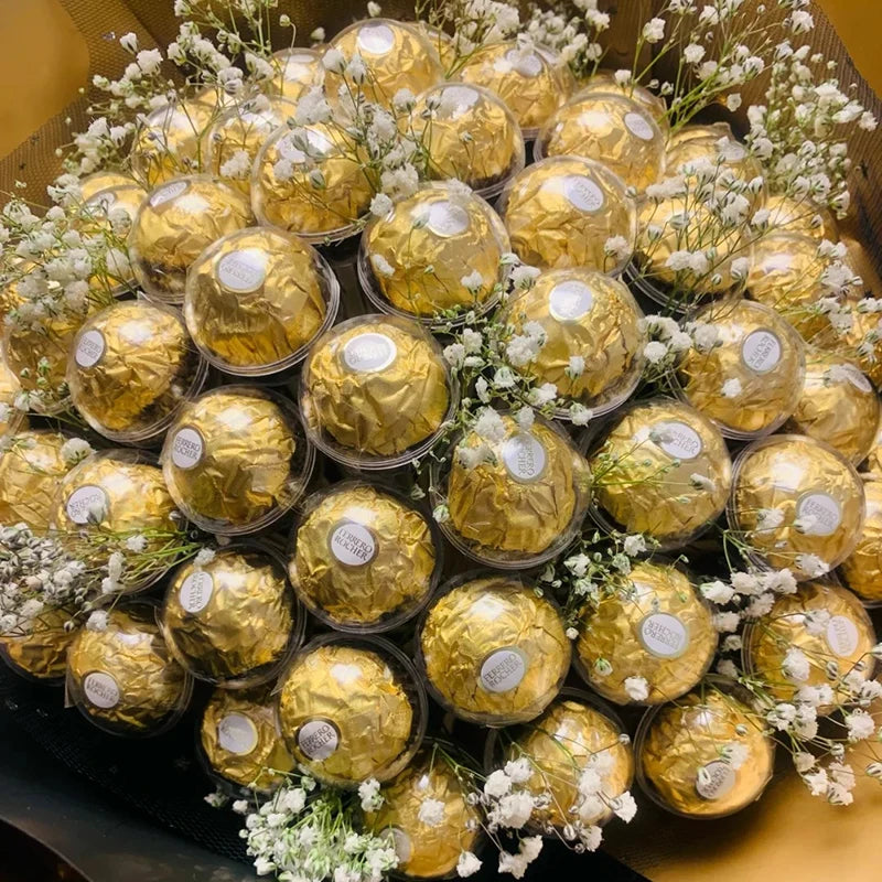 Bouquet of gold Ferrero Rocher chocolates and white flowers in a box