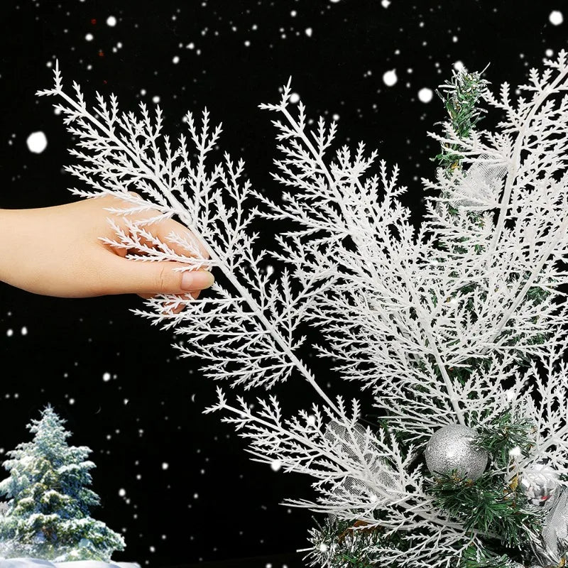 Decorative white branch with a hand touching it against a snowy background