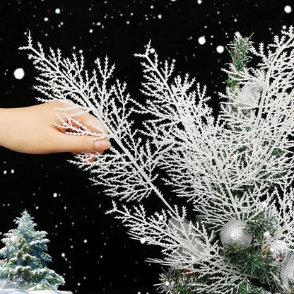 Decorative white branch with a hand touching it against a snowy background