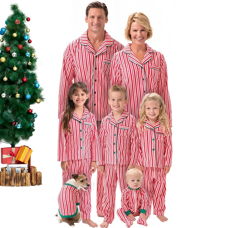 Family of five wearing red and white striped pajamas with a Christmas tree and presents in the background.