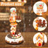Decorative Christmas figure with gingerbread men and a house, showing product size on a wooden surface.