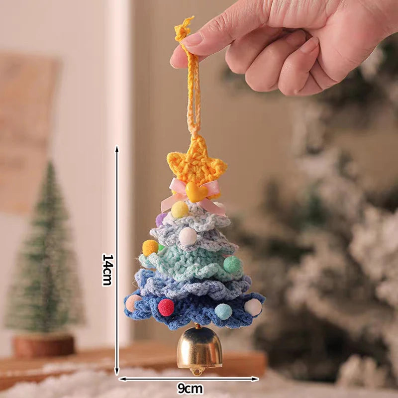 Hand holding a crocheted Christmas tree ornament with measurements indicated.