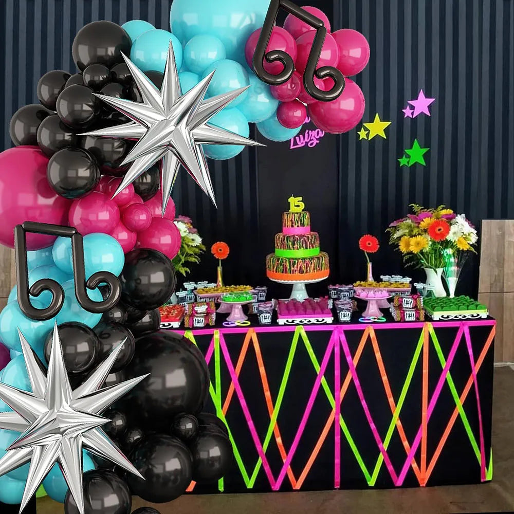 Decorative setup with balloons, cake, and flowers on a table against a dark curtain. Titktok Themed Balloons
