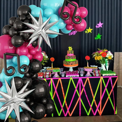 Decorative setup with balloons, cake, and flowers on a table against a dark curtain. Titktok Themed Balloons