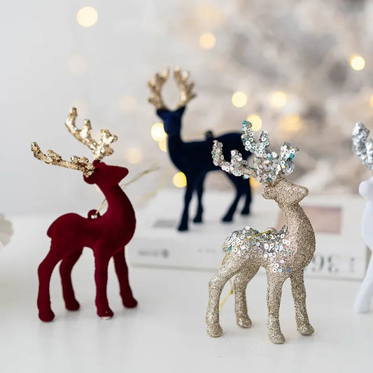 Decorative reindeer figurines with glittery antlers on a blurred background