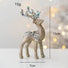 Decorative gold reindeer figure with sequins and measurements on a light background
