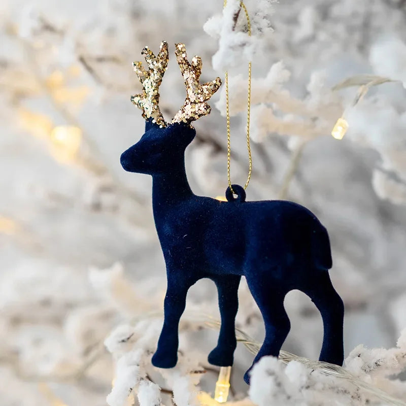 Navy blue deer ornament with gold antlers on a snowy branch background