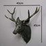 Antique Silver deer head sculpture with measurements on a white background