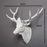 White deer head sculpture with measurements on a gray background