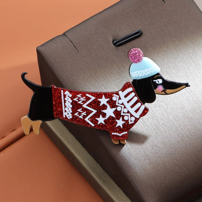 Decorative dog figurine wearing a red sweater and blue and white hat on a suitcase.