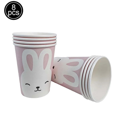 Set of eight pink paper cups with bunny designs on a white background
