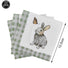 Set of napkins with a rabbit and butterfly design, including green checkered napkins.