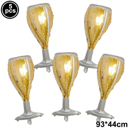 Five gold and silver inflatable champagne glass balloons on a white background.