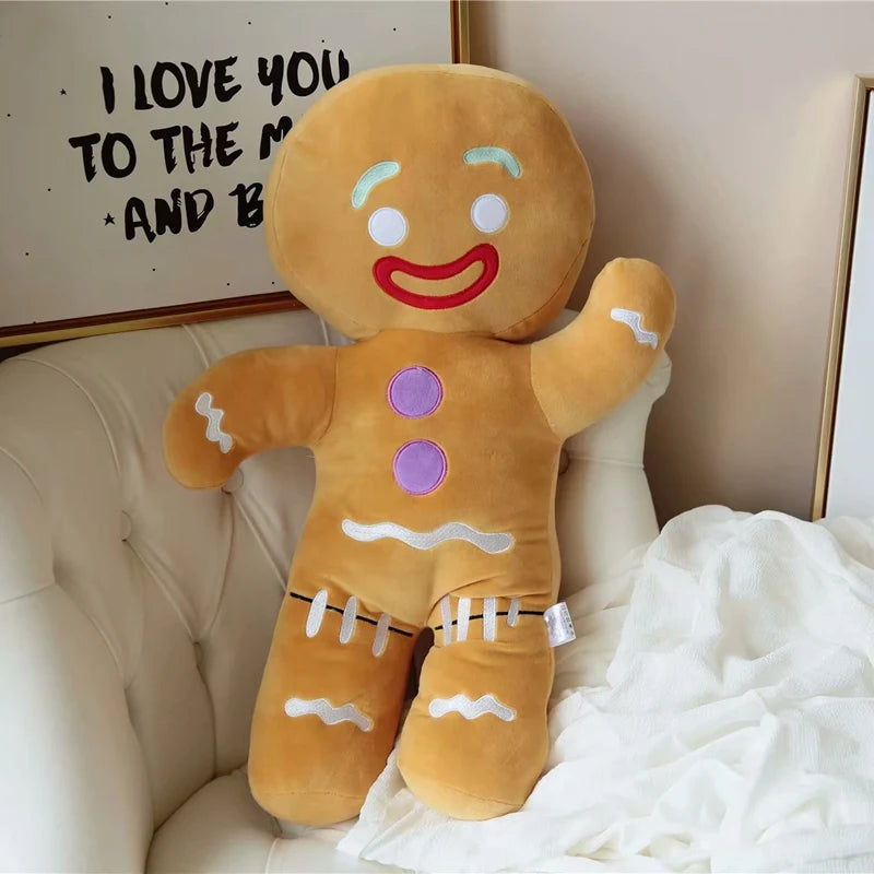 Plush gingerbread man toy on a couch with a decorative wall in the background