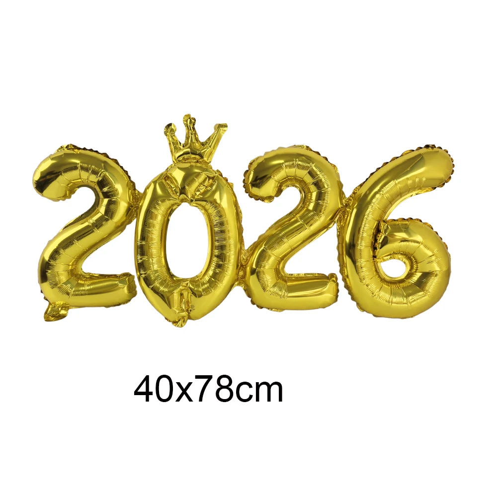 Gold foil balloons shaped like '2026' with a crown on a white background
