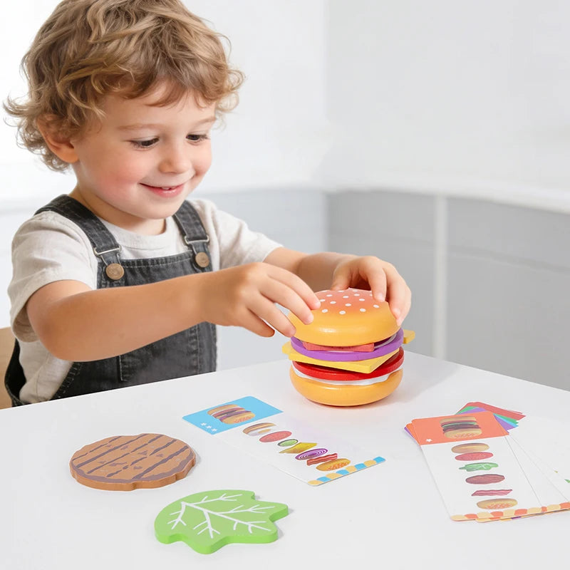 Child playing with a colorful toy hamburger set on a table.