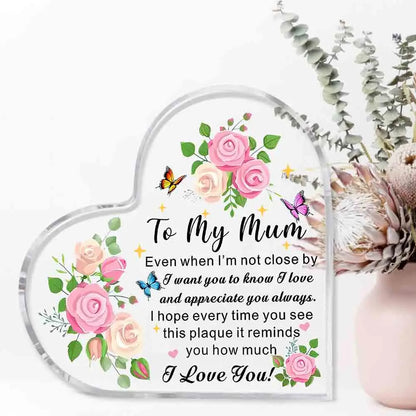 Heart-shaped plaque with floral design and message to 'My Mum' on a white background