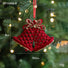 Red bell-shaped ornament with gold accents on a Christmas tree, showing measurements.