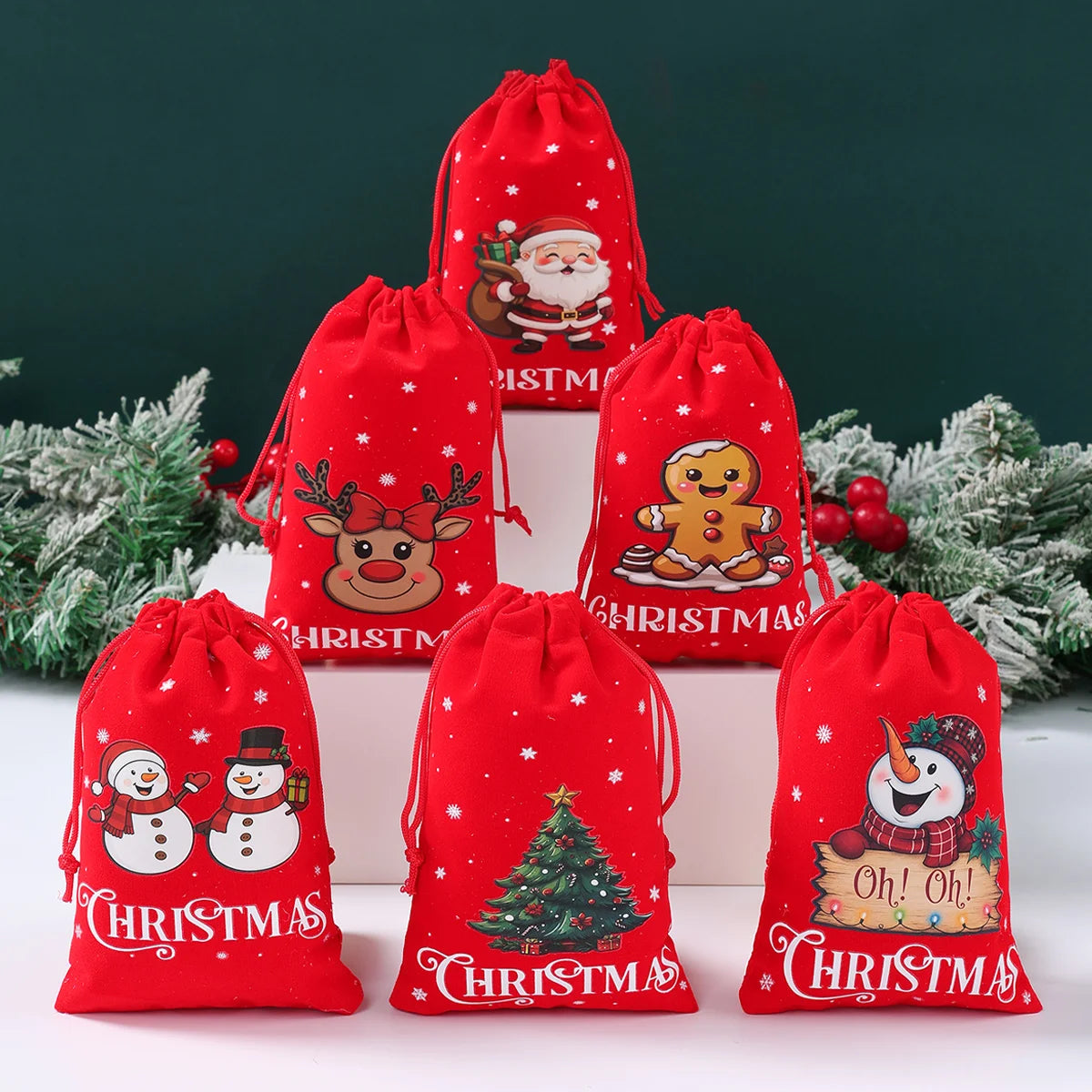 Set of red Christmas-themed drawstring bags with various festive designs on a white surface.