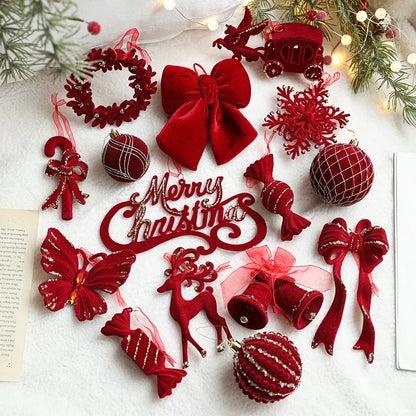 Collection of red Christmas ornaments on a white surface with festive decorations.