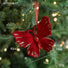 Red butterfly ornament with gold accents on a Christmas tree, showing measurements.