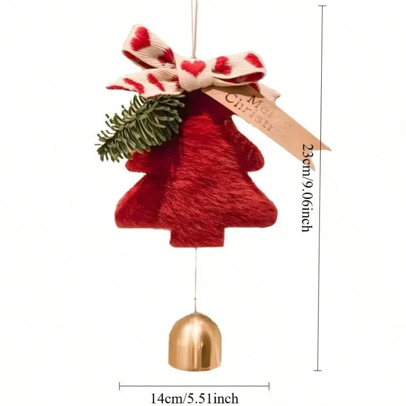 A red Christmas tree ornament with a gold bell hanging below, decorated with a red-and-white patterned bow, cream ribbon, and green pine branch. Measurement lines and text indicate dimensions of 23cm/9.