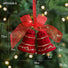 Red Christmas bell ornament with gold accents and a red bow, shown with measurements against a blurred Christmas tree background.
