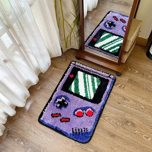 Game console-shaped rug on a wooden floor with a mirror reflecting the rug.