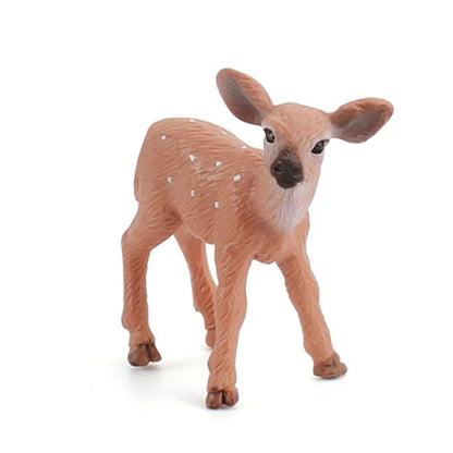 A small plastic toy fawn figurine with brown fur and white spots, standing on a white background.