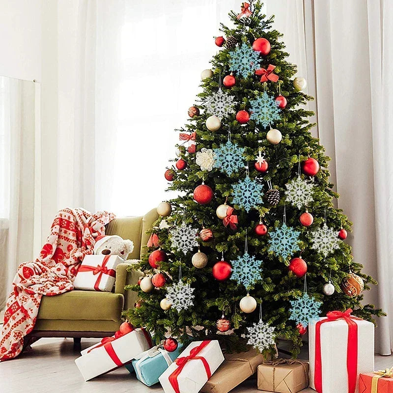 Decorated Christmas tree with snowflake ornaments and presents in a living room.