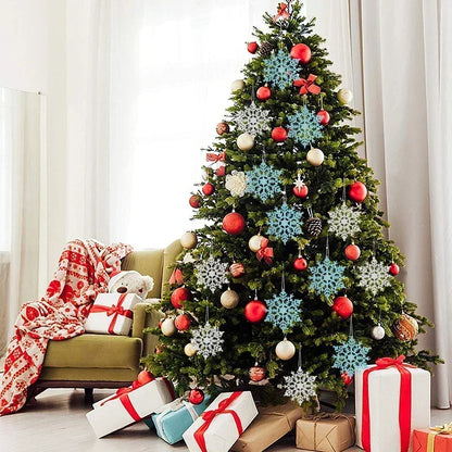 Decorated Christmas tree with snowflake ornaments and presents in a living room.