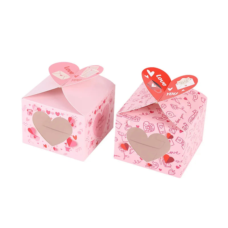 Two pink gift boxes with heart designs on a white background