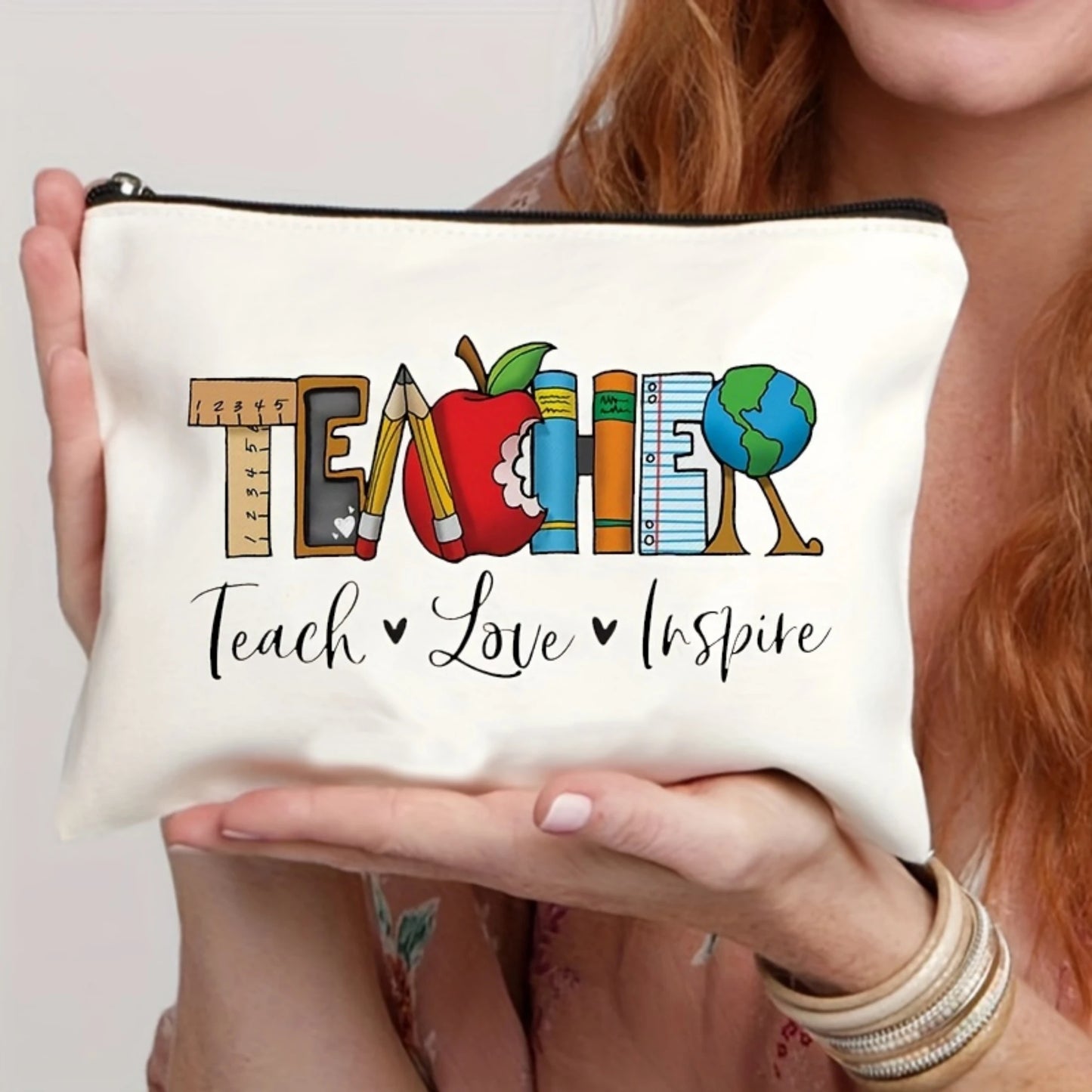 Person holding a  pencil case with 'Teacher Teach Love Inspire' text and educational icons.