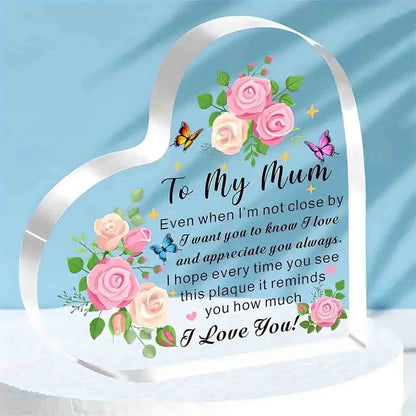 Heart-shaped plaque with floral design and message to 'My Mum' on a blue background