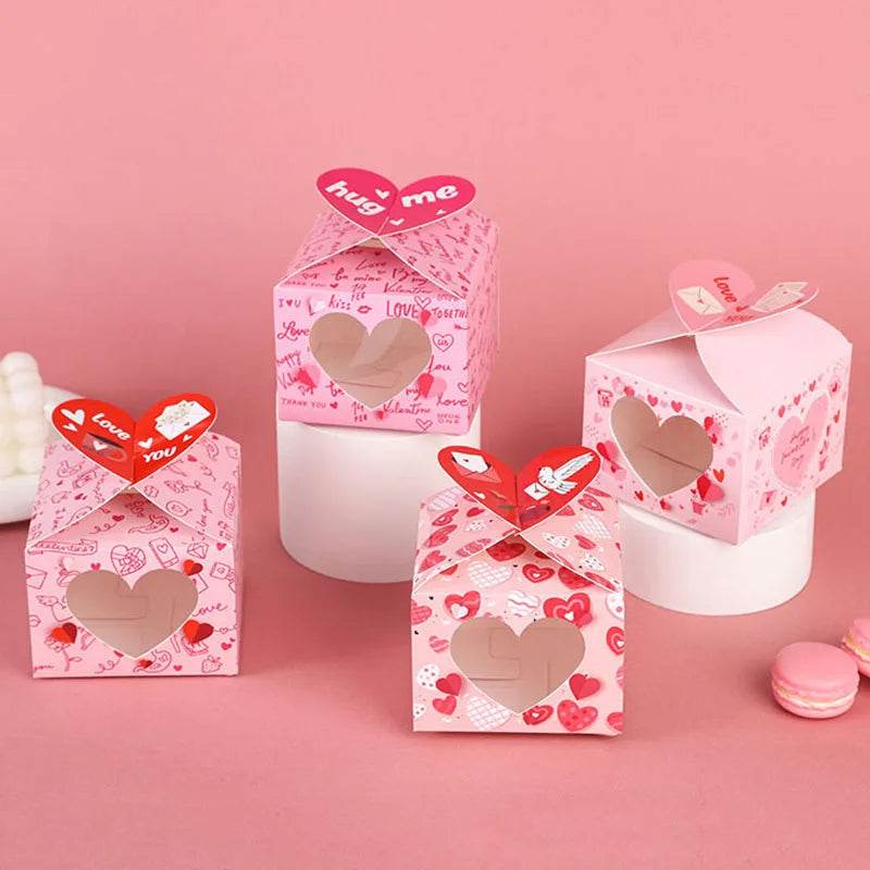 Heart-shaped gift boxes with Valentine's Day designs on a pink background