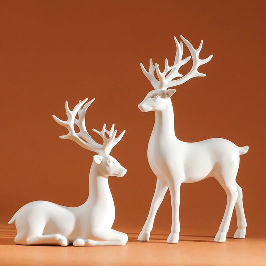 Two white deer figurines on a brown background