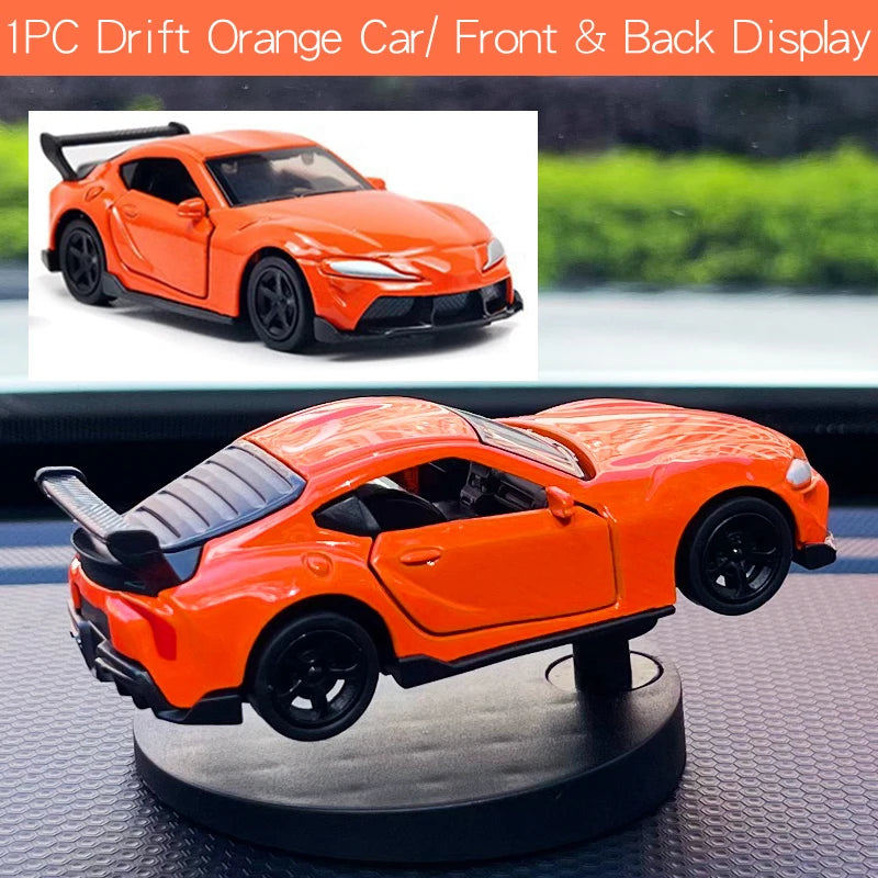 Orange toy car on a rotating stand with a scenic background